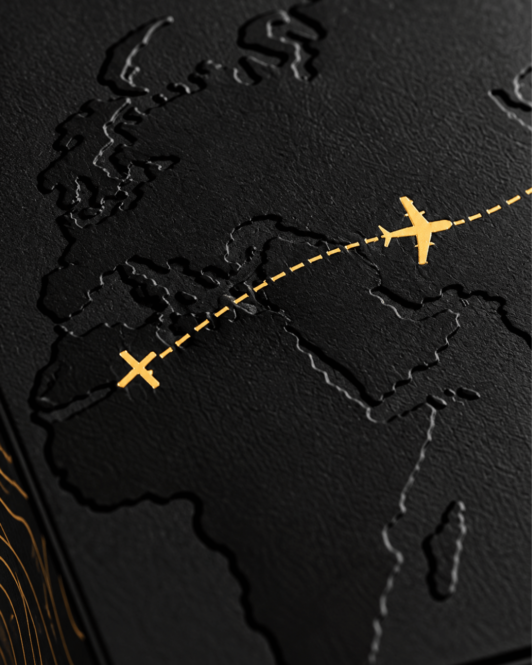 Close-up of the box lid: embossed map with a gold plane on a dashed route