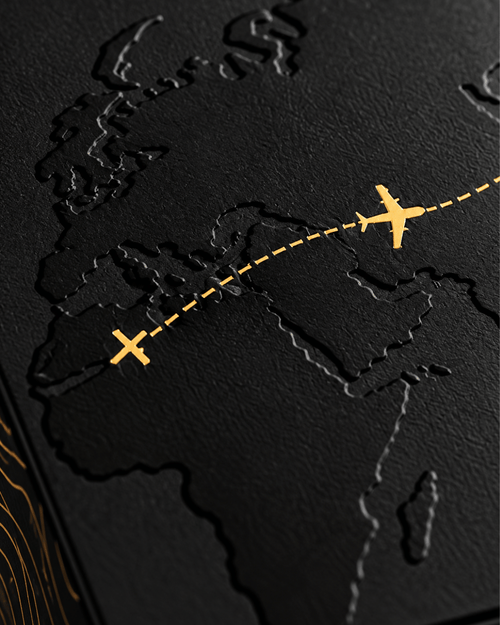 Close-up of the box lid: embossed map with a gold plane on a dashed route